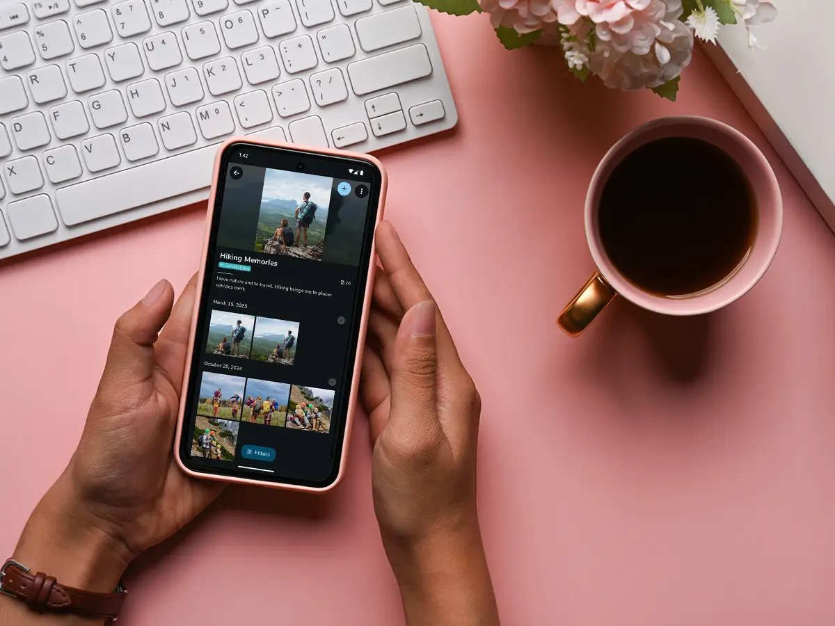 Hands holding a phone displaying the FOREVER mobile app's Hiking Memories album